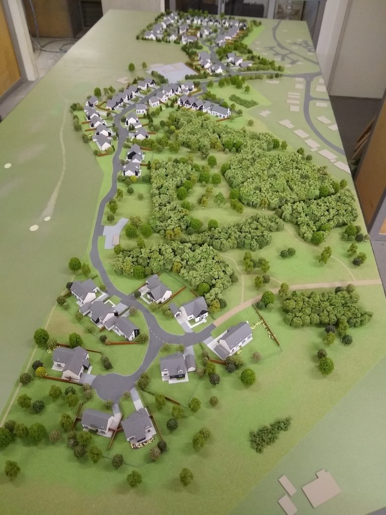 model-makers serving Aviemore . Housing model with adjacent golf course and forest